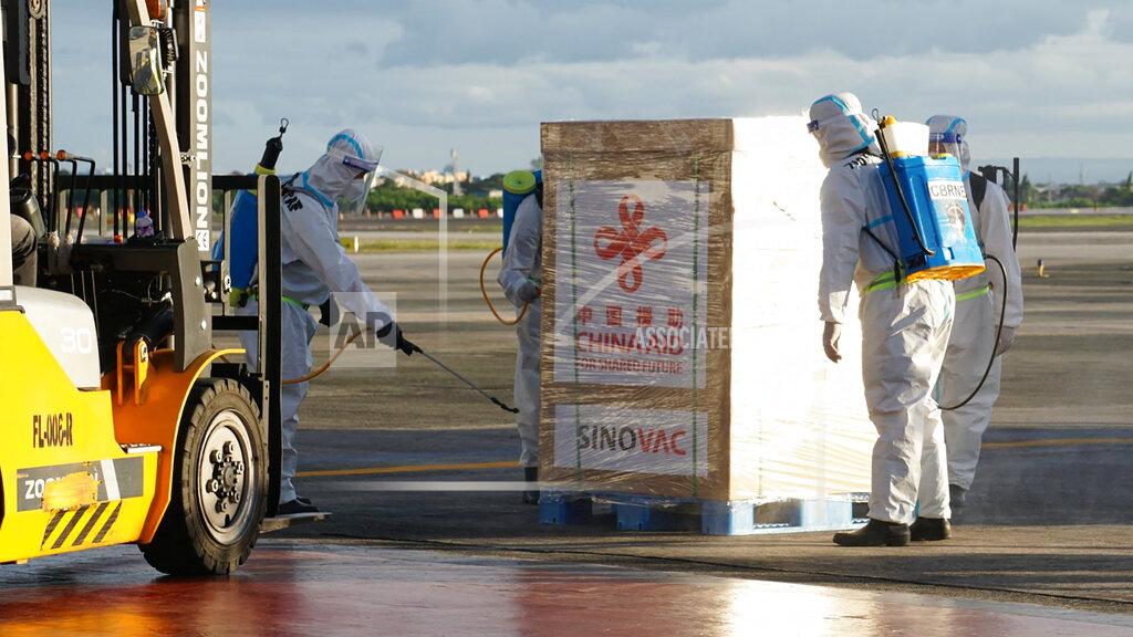 Uncredited In this photo provided by the Presidential Communications Operations Office-Office of the Global Media Public Affairs, the first batch of Sinovac vaccine from China is sanitized as it arrives at the Villamor Air Base in Manila, Philippines on Sunday Feb. 28, 2021. The Philippines is due to receive its first batch of COVID-19 vaccine Sunday, among the last in Southeast Asia to secure the critical doses despite having the second-highest number of coronavirus infections and deaths in the hard-hit region. (PCOO-OGMPA via AP)