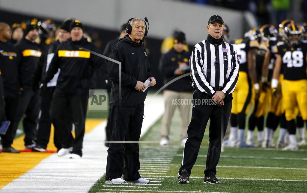 Iowa head coach Kirk Ferentz, left, watches a replay during the second half of an NCAA college football game against Northwestern, Saturday, Nov. 10, 2018, in Iowa City, Iowa. Northwestern won 14-10. (AP Photo/Charlie Neibergall)