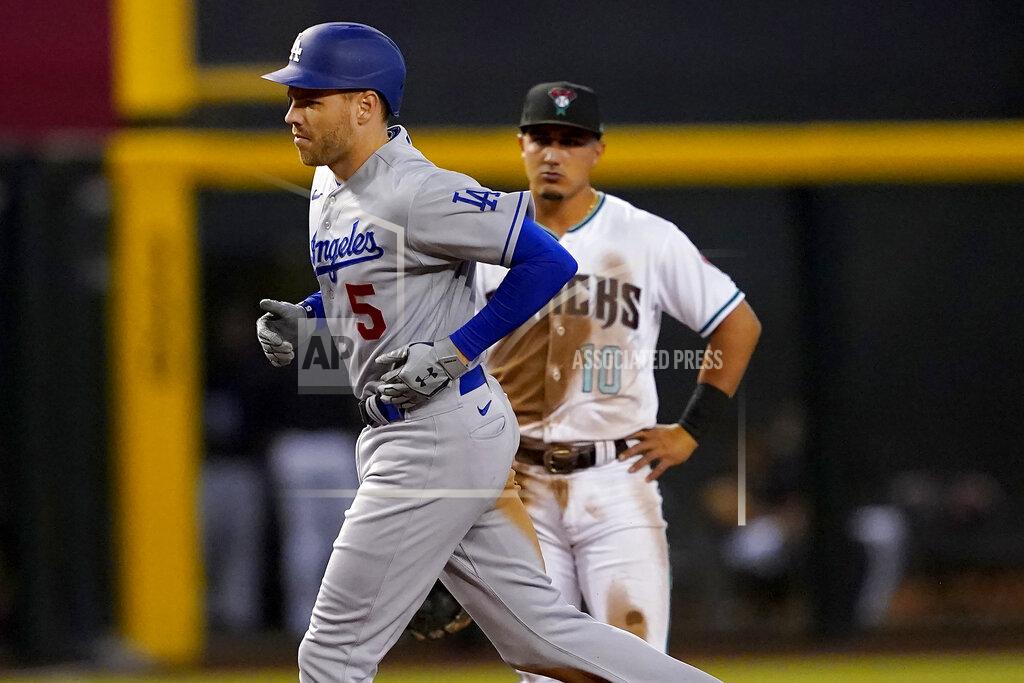 Matt York Los Angeles Dodgers' Freddie Freeman rounds the bases after hitting a three-run home run as Arizona Diamondbacks Josh Rojas (10) looks on during the second inning of a baseball game, Thursday, May 26, 2022, in Phoenix. (AP Photo/Matt York)