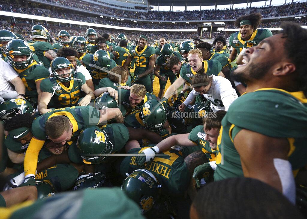 Rod Aydelotte Baylor players mob Baylor running back JaMycal Hasty after his game winning touchdown in overtime against Texas Tech after a NCAA college football game, Saturday, Oct. 12, 2019, in Waco, Texas. Baylor won 33-30. (Rod Aydelotte/Waco Tribune Herald via AP)