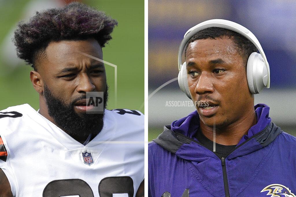 At left in a Dec. 6, 2020, photo, Cleveland Browns wide receiver Jarvis Landry warms up before an NFL football game against the Tennessee Titans in Nashville, Tenn. At right in a Sept. 28, 2020, photo, Baltimore Ravens cornerback Marcus Peters warms up before an NFL football game against the Kansas City Chiefs in Baltimore. Browns wide receiver Jarvis Landry called Ravens cornerback Marcus Peters “a coward” for appearing to spit at him during Monday night's, Dec. 14 game. A video taken from the national TV broadcast shows Peters spitting in Landry's direction at the end of the first quarter. (AP Photo)