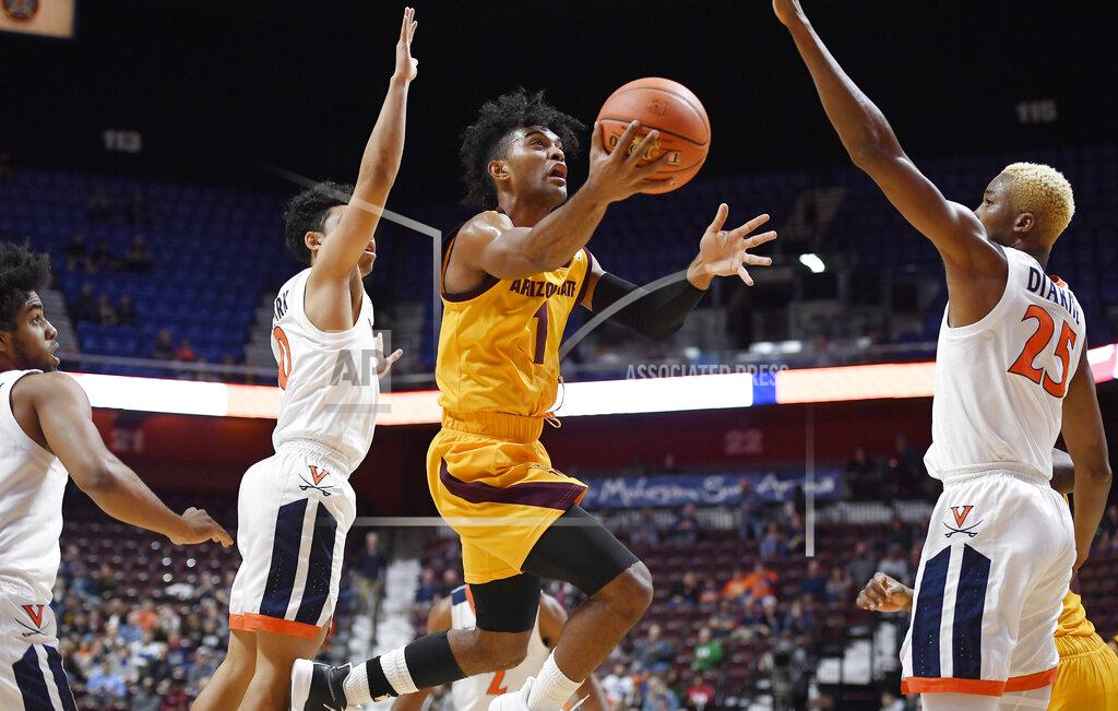 Jessica Hill Arizona State's Remy Martin, center, shoots between Virginia's Kihei Clark, left, and Virginia's Mamadi Diakite, right, during the first half of an NCAA college basketball game, Sunday, Nov. 24, 2019, in Uncasville, Conn. (AP Photo/Jessica Hill)