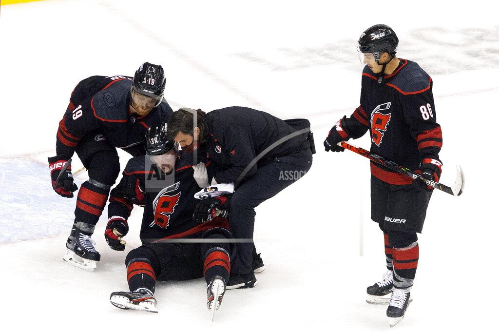 Chris Young Carolina Hurricanes' Andrei Svechnikov is helped up after being injured against the Boston Bruins during third period NHL Eastern Conference Stanley Cup playoff game in Toronto on Saturday, Aug. 15, 2020. (Chris Young/The Canadian Press via AP)