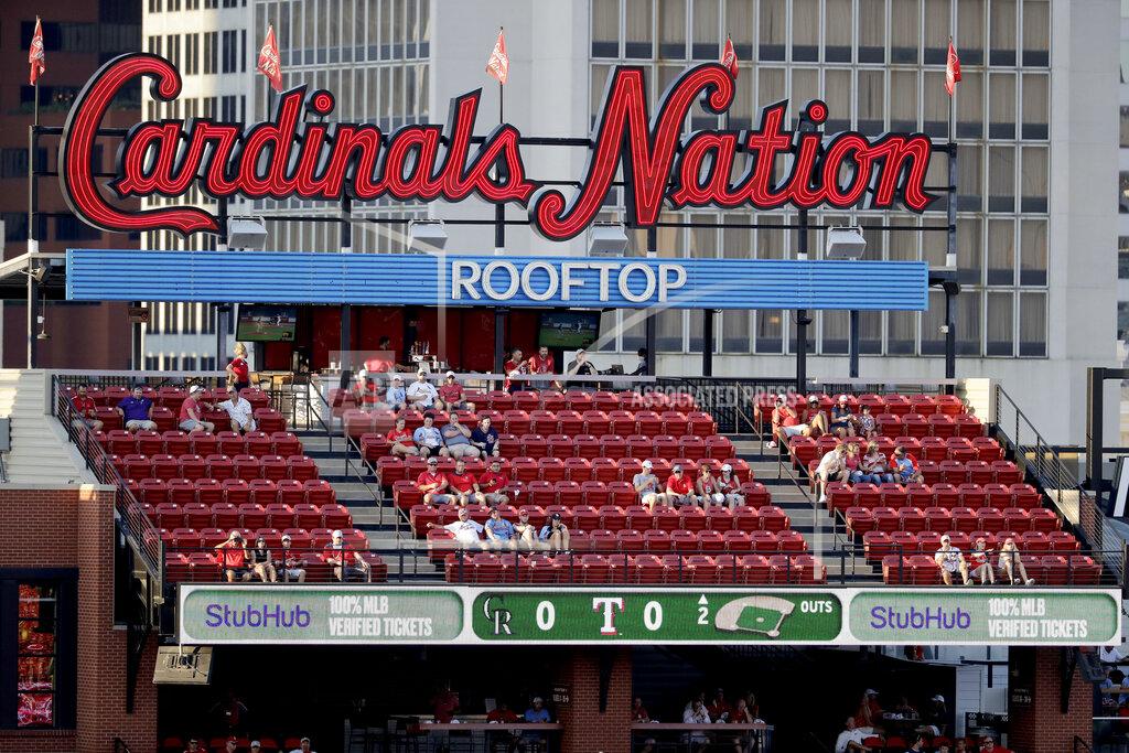 Jeff Roberson A few fans watch the action from seats across the street outside Busch Stadium as the St. Louis Cardinals and Pittsburgh Pirates play an opening day baseball game without fans in the stadium Friday, July 24, 2020, in St. Louis. (AP Photo/Jeff Roberson)