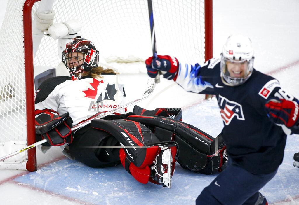 Jeff Mcintosh Canada's goalie Ann-Renee Desbiens, left, reacts after letting in a goal as United States' Jesse Compher celebrates during the third period of an IIHF women’s world hockey championships game Thursday, Aug. 26, 2021, in Calgary, Alberta. (Jeff McIntosh/The Canadian Press via AP)