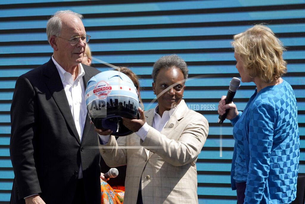 Charles Rex Arbogast NASCAR CEO Jim France, left, and Executive Vice President Lesa Kennedy, right, present Chicago Mayor Lori Lightfoot with a racing helmet Tuesday, July 19, 2022, in Chicago after a news conference where the racing body announced a Cup Series street race to be held July 2, 2023, in the city. (AP Photo/Charles Rex Arbogast)
