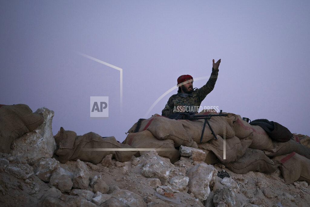 Felipe Dana A U.S.-backed Syrian Democratic Forces (SDF) fighter reacts as an airstrike hits territory held by Islamic State militants in the desert outside Baghouz, Syria, Tuesday, Feb. 19, 2019. The Islamic State group has been reduced from its self-proclaimed caliphate that once spread across much of Syria and Iraq at its height in 2014 to a speck of land on the countries' shared border. (AP Photo/Felipe Dana)
