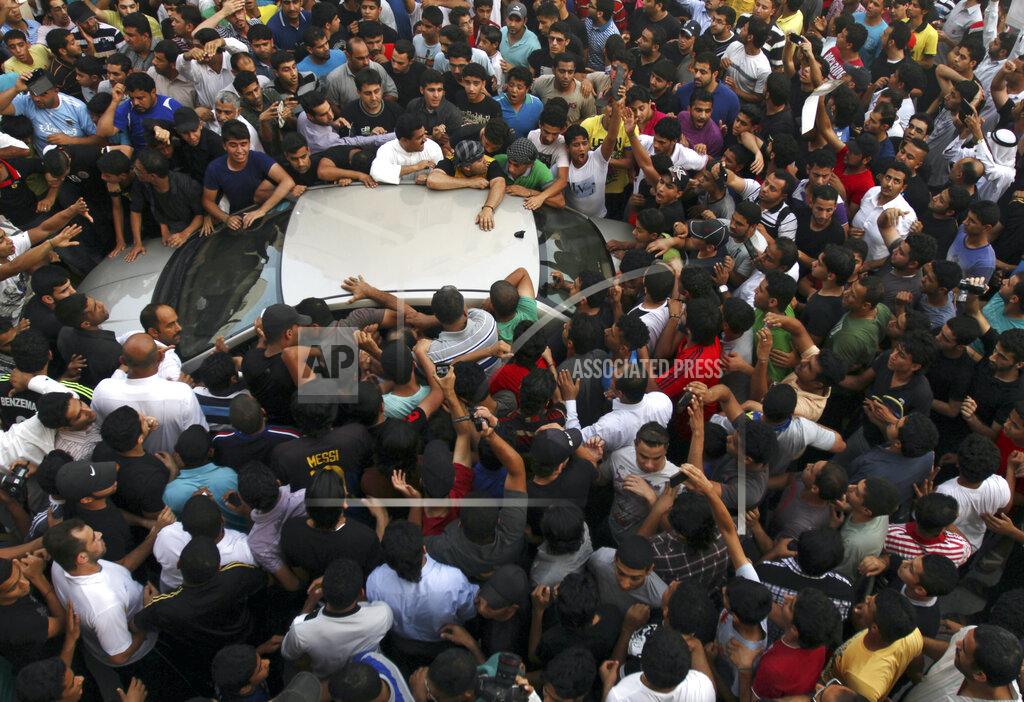 Hasan Jamali File - In this Monday, May 20, 2013 file photo, crowds rush to greet Bahraini Shiite opposition political leader Abdul Wahab Hussein, inside vehicle, as he arrives from prison to his home in Nuwaidrat, Bahrain. A decade ago, against all odds, a popular uprising convulsed the monarchy of Bahrain as a wave of revolutionary protests swept across the Middle East. But after a brutal crackdown and years of escalating repression, activists say the small kingdom is less free now than even before the Arab Spring, as authorities crush hopes for political reform. (AP Photo/Hasan Jamali, File)