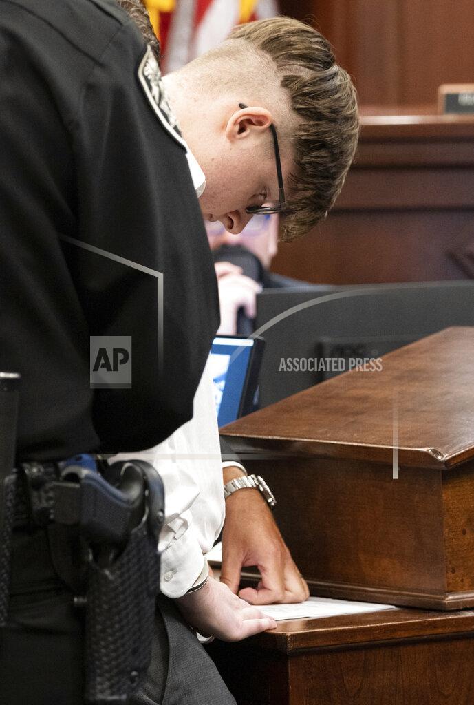 Ben Gray Robert Aaron Long finalizes his plea before Judge Ellen McElyea in Superior Court of Cherokee County in Canton, Ga. on Tuesday, July 27, 2021. The man accused of killing eight people, most of them women of Asian descent, at Atlanta-area massage businesses pleaded guilty to four of the murders. He was handed four sentences of life without parole. Robert Aaron Long still faces the death penalty in the four other deaths, which are being prosecuted in a different county. (Ben Gray/Atlanta Journal-Constitution via AP, Pool)