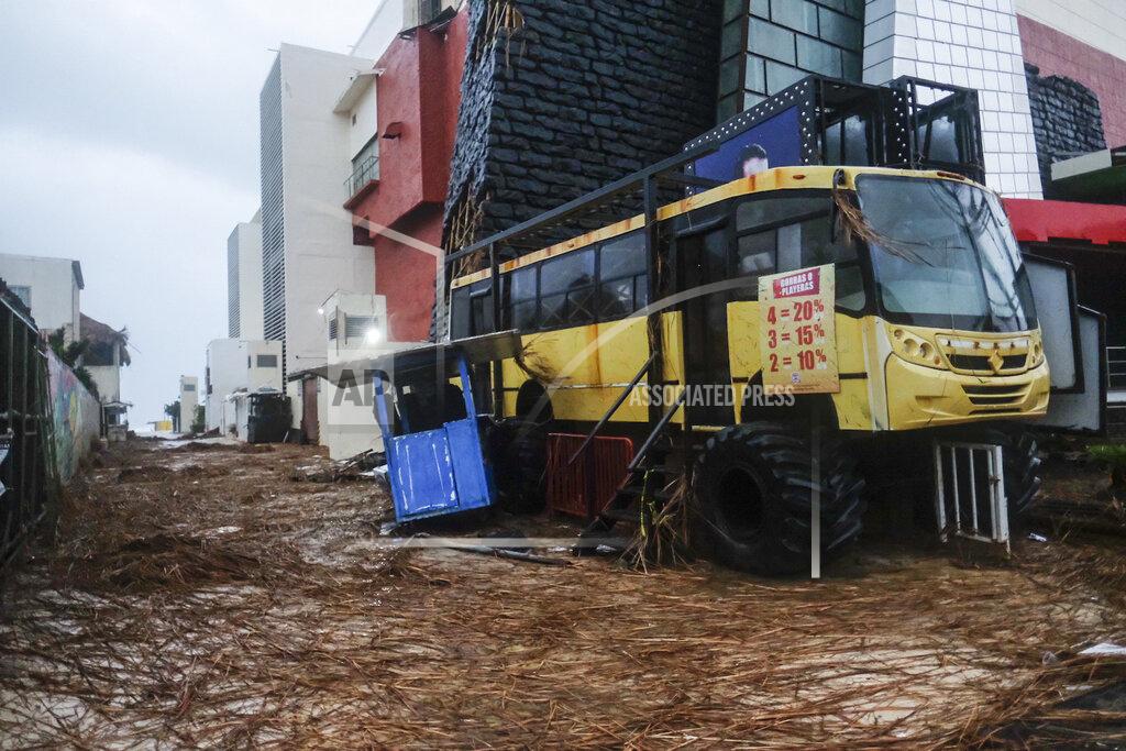 Victor Ruiz Garcia Tree debris fills a street where a kiosk stands crooked in the aftermath of Hurricane Delta in Cancun, Mexico, Wednesday, Oct. 7, 2020. Hurricane Delta made landfall Wednesday just south of the Mexican resort of Cancun as a Category 2 storm, downing trees and knocking out power to some resorts along the northeastern coast of the Yucatan Peninsula. (AP Photo/Victor Ruiz Garcia)