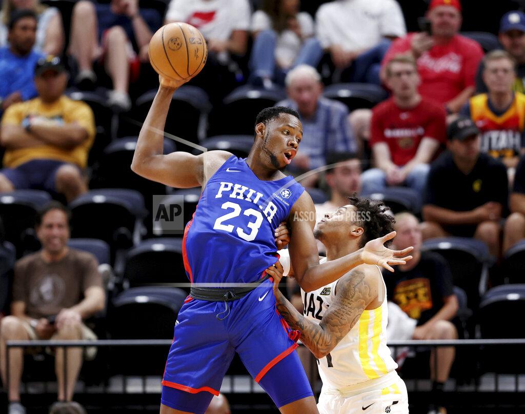 Scott G. Winterton Philadelphia 76's Charles Bassey (23) brings down a high pass and tries to spin to the hoop on Utah Jazz's Caleb Homesley (61) in summer league basketball game in Salt Lake City on Wednesday, July 6, 2022. (Scott G Winterton/The Deseret News via AP)