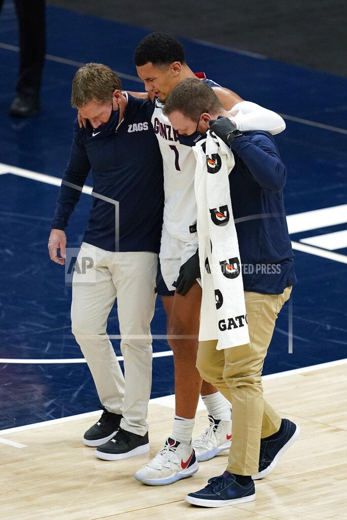 Darron Cummings Gonzaga coach Mark Few, left, helps Jalen Suggs (1) off the court during the first half of the team's NCAA college basketball game against West Virginia, Wednesday, Dec. 2, 2020, in Indianapolis. (AP Photo/Darron Cummings)