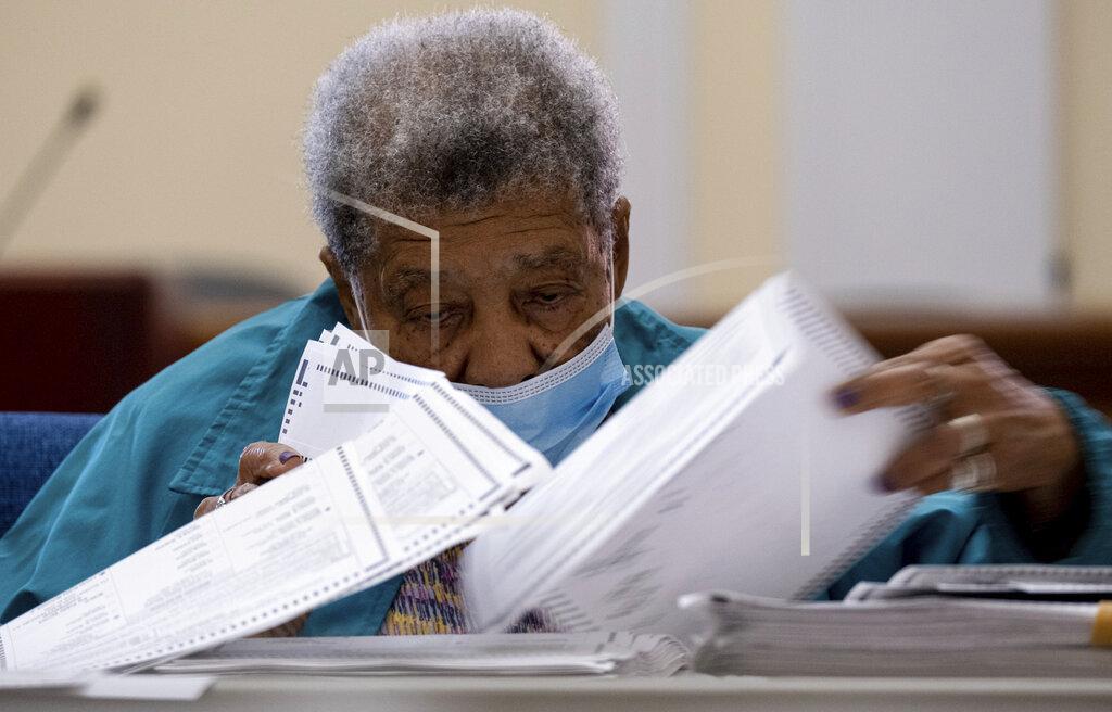 Ben Gray Officials sort ballots during an audit at the Floyd County administration building in Rome, Ga. on Friday morning, Nov. 13, 2020. Election officials in Georgia’s 159 counties are undertaking a hand tally of the presidential race that stems from an audit required by state law. (AP Photo/Ben Gray)