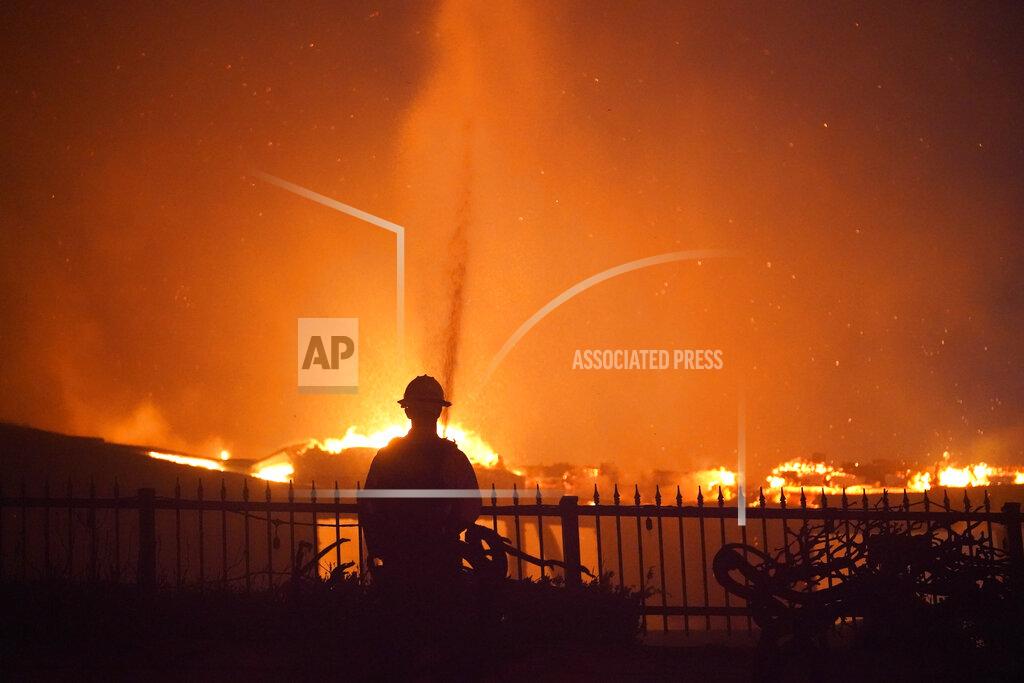 Marcio J. Sanchez A firefighter works to put out a structure burning during a wildfire Wednesday, May 11, 2022, in Laguna Niguel, Calif. (AP Photo/Marcio J. Sanchez)