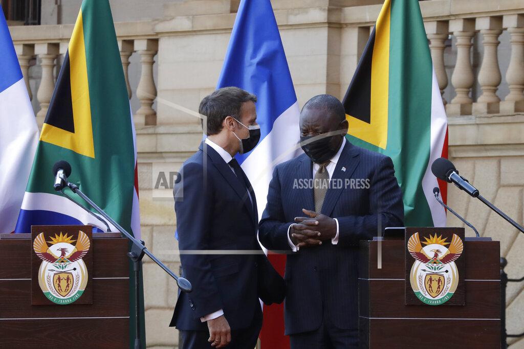 Themba Hadebe South African President Cyril Ramaphosa, right, and his French counterpart Emmanuel Macron speak during a press conference at the government's Union Building, in Pretoria, South Africa, Friday, May 28, 2021. Macron is on a two-day official visit to the country. (AP Photo/Themba Hadebe, Pool)