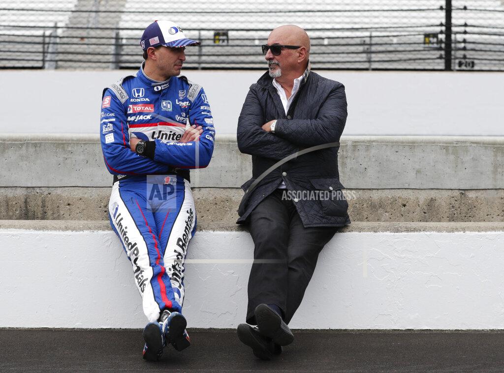 FILE - In this April 24, 2019, file photo, Graham Rahal talks with his father and car owner, Bobby Rahal, before testing at Indianapolis Motor Speedway in Indianapolis. Rahal is grateful for most of the genes he inherited from his father. The one he gene he could have gone without? His large frame. Rahal is the largest driver in IndyCar and revealed this week he's undergoing body contouring treatments in his battle with the bulge. He's had one treatment of "Sculpsure” and is committed to the process described as non-invasive, light-based technology that targets fat cells. (AP Photo/Michael Conroy, File)