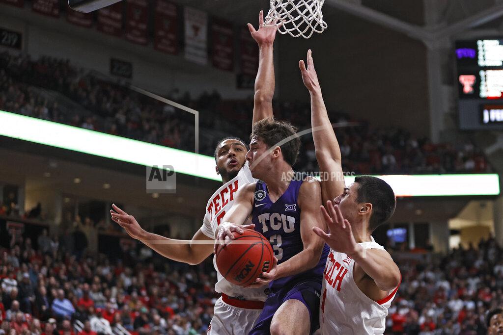 Brad Tollefson TCU's Francisco Farabello (3) passes the ball around Texas Tech's Kevin Obanor (0) and Daniel Batcho (4) during the first half of an NCAA college basketball game on Saturday, Feb. 12, 2022, in Lubbock, Texas. (AP Photo/Brad Tollefson)