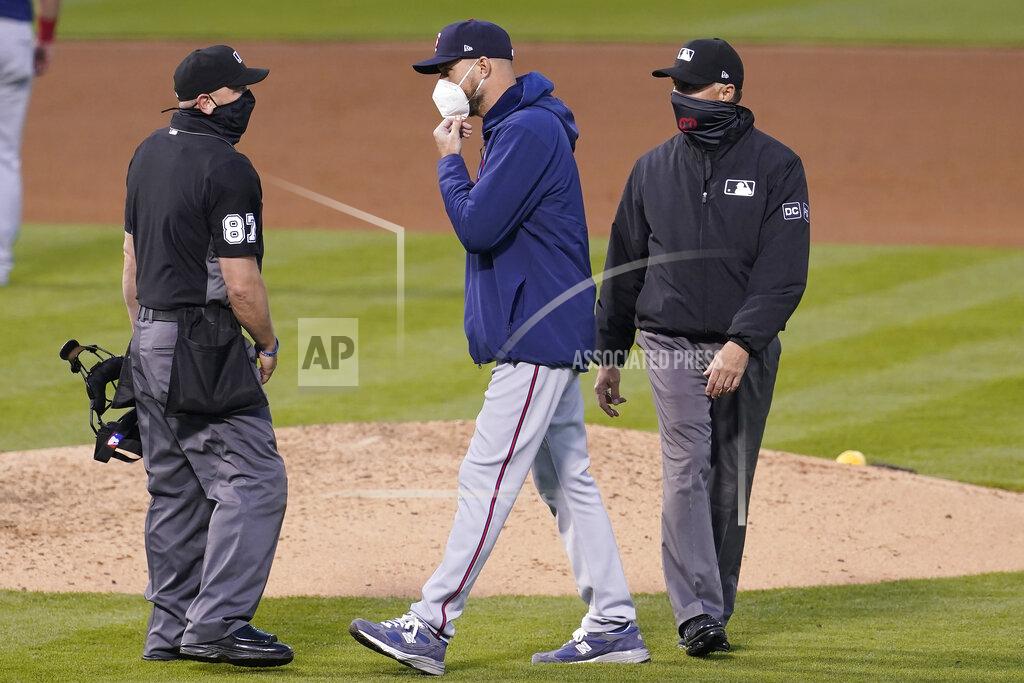 Jeff Chiu Minnesota Twins manager Rocco Baldelli, middle, talks with umpire Scott Barry (87) during the fourth inning of the second baseball game of a doubleheader between the Oakland Athletics and the Twins in Oakland, Calif., Tuesday, April 20, 2021. (AP Photo/Jeff Chiu)