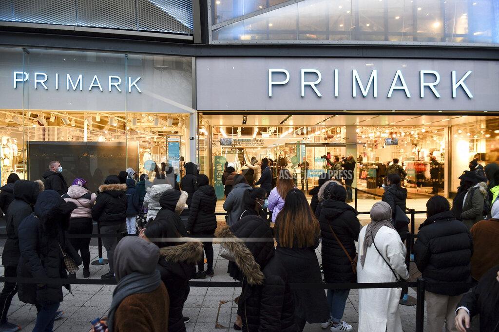 Jacob King Early morning shoppers in Birmingham, England, Monday April 12, 2021. Millions of people in Britain will get their first chance in months for haircuts, casual shopping and restaurant meals on Monday, as the government takes the next step on its lockdown-lifting road map. (Jacob King/PA via AP)