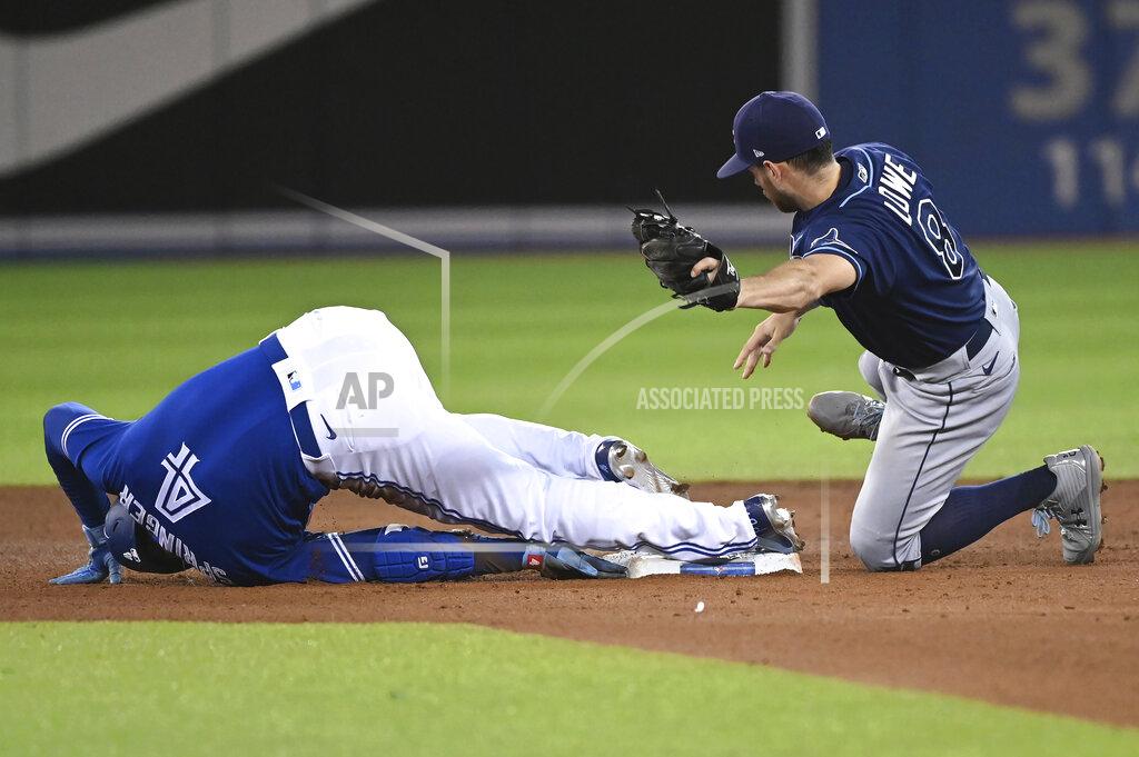 Jon Blacker Toronto Blue Jays' George Springer (4) slides into second base with a double ahead of the tag by Tampa Bay Rays' Brandon Lowe during the fourth inning of a baseball game Tuesday, Sept. 14, 2021, in Toronto. (Jon Blacker/The Canadian Press via AP)