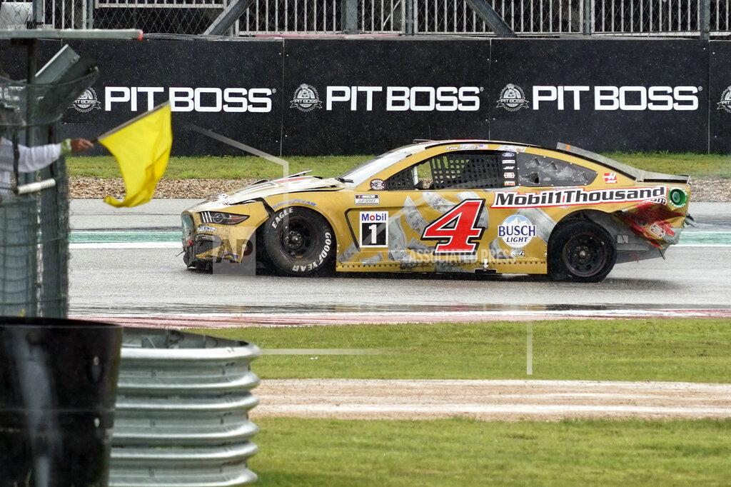 Chuck Burton Kevin Harvick (4) drives past a yellow flag in Turn 15 after a crash during a NASCAR Cup Series auto race at Circuit of the Americas in Austin, Texas, Sunday, May 23, 2021. (AP Photo/Chuck Burton)