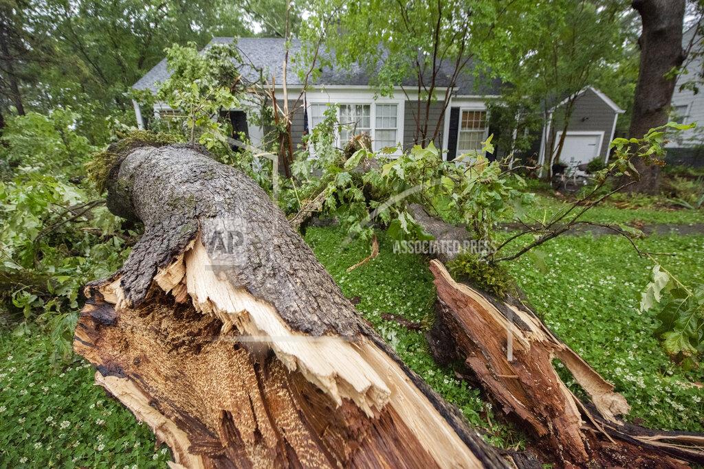 Barbara Gauntt A tree just scraps the front of the Hadden home in Fondren in Jackson, Miss., after falling during severe weather that moved through the Jackson, Miss., metro area Tuesday afternoon, May 4, 2021. "I was just looking at that tree, thinking, 'I probably need to get that cut down,'"said Lisa Hadden, of Jackson, Miss. (Barbara Gauntt/The Clarion-Ledger via AP)
