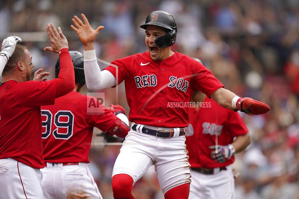 Steven Senne Boston Red Sox's Enrique Hernandez, center, celebrates with teammates after scoring on a sacrifice fly by Xander Bogaerts in the eighth inning of a baseball game against the New York Yankees, Sunday, July 25, 2021, in Boston. (AP Photo/Steven Senne)