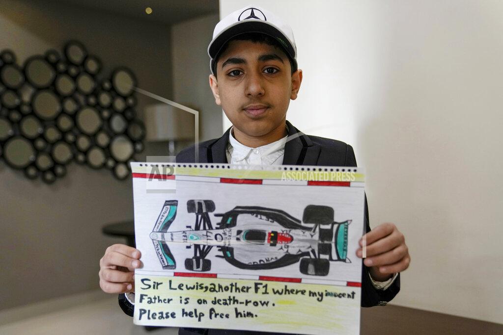 Uncredited Ahmed, 12 years old, son of Mohammed Ramadhan, a former member of Bahrain's security forces who is facing the death penalty in Bahrain, holds a drawing he made of F1 driver Lewis Hamilton's Formula One car in Manama, Bahrain, Thursday, March 17, 2022. Ahead of Sunday's season-opening F1 race in Bahrain, Ahmed proudly held up the drawing of Hamilton's famed No. 44 Mercedes car along with his own words of hope: "Sir Lewis, another F1 where my innocent father is on death row. Please help free him." (AP Photo)