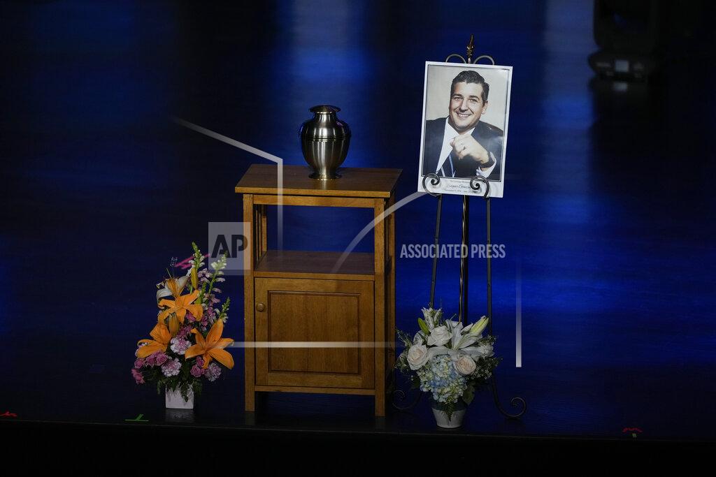 Rebecca Blackwell A portrait of Edgar Gonzalez, 44, who was killed last month in the Champlain Towers South condominium collapse, is displayed next to his urn during a funeral service, Friday, July 23, 2021, at Christ Fellowship church in Palmetto Bay, Fla. Gonzalez' wife Angela and daughter Deven were injured but survived the collapse, falling multiple stories.(AP Photo/Rebecca Blackwell)