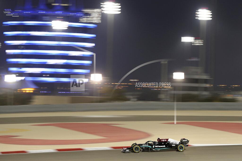 Kamran Jebreili Mercedes driver Lewis Hamilton of Britain steers his car during the second free practice at the Formula One Bahrain International Circuit in Sakhir, Bahrain, Friday, March 26, 2021. The Bahrain Formula One Grand Prix will take place on Sunday. (AP Photo/Kamran Jebreili)