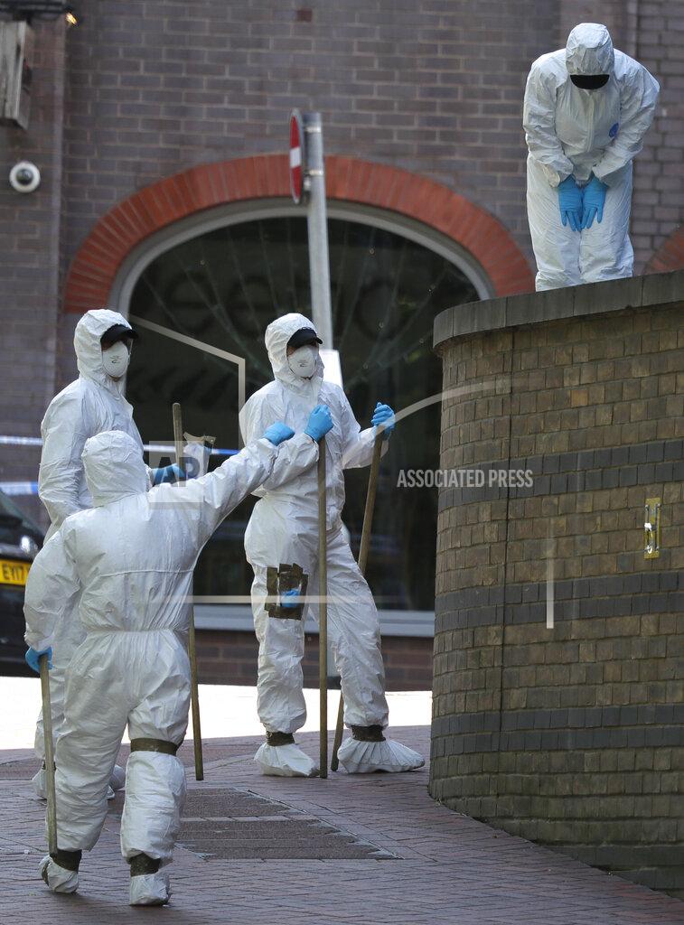 Police forensic officers search near the scene of a fatal multiple stabbing attack in Forbury Gardens, central Reading, England, Monday June 22, 2020. The English town of Reading is mourning for three people stabbed to death on Saturday in what is being treated as a terror attack. Residents gathered for a moment of silence Monday as police questioned the suspected lone wolf attacker. (AP Photo/Kirsty Wigglesworth)
