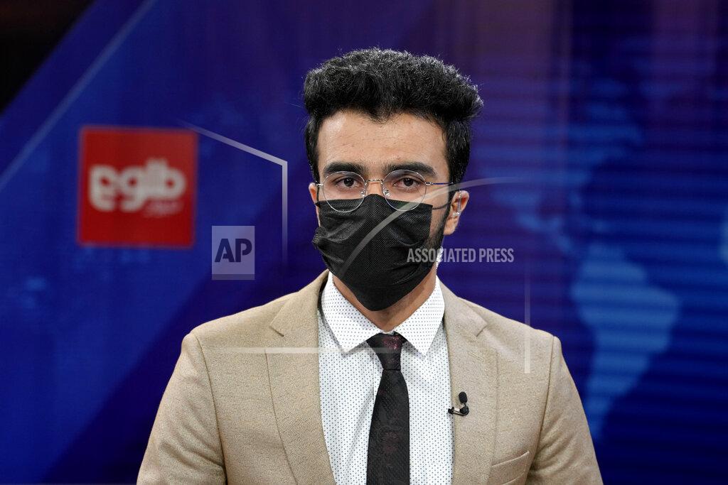 Ebrahim Noroozi TV anchor Hamed Bahram wears a face mask to protest the Taliban's new order that female presenters cover their faces as he reads the news on TOLOnews, in Kabul, Afghanistan, Sunday, May 22, 2022. Afghanistan's Taliban rulers have begun enforcing an order requiring all female TV news anchors in the country to cover their faces while on-air. The move Sunday is part of a hard-line shift drawing condemnation from rights activists. (AP Photo/Ebrahim Noroozi)