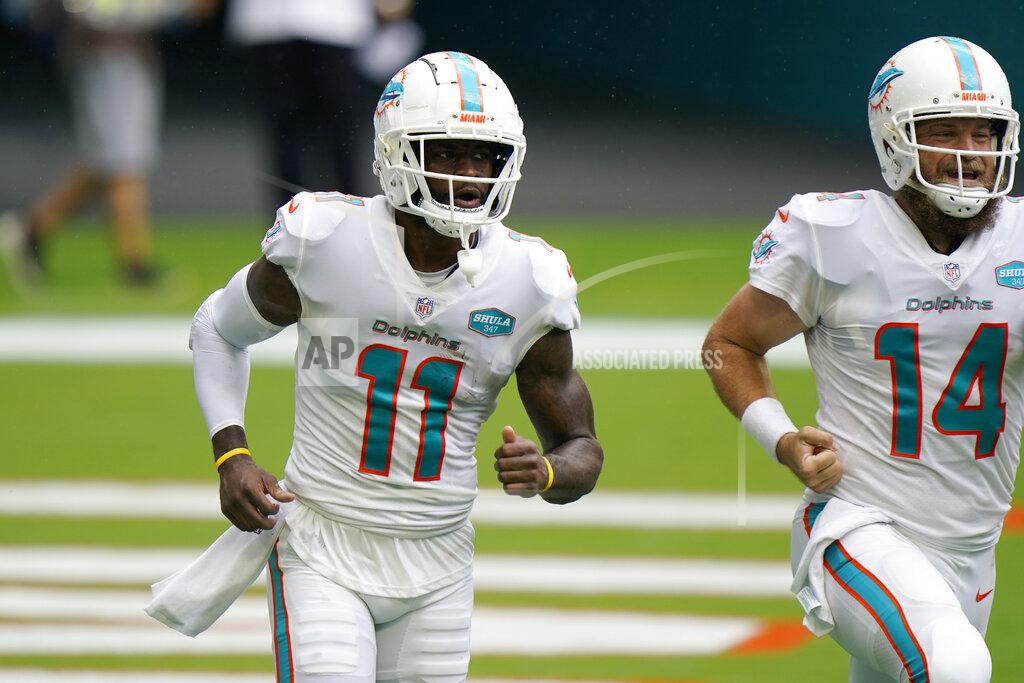 Wilfredo Lee Miami Dolphins wide receiver DeVante Parker (11) and quarterback Ryan Fitzpatrick (14) return to the bench after Parker scored a touchdown, during the first half of an NFL football game against the Buffalo Bills, Sunday, Sept. 20, 2020 in Miami Gardens, Fla. (AP Photo/Wilfredo Lee)