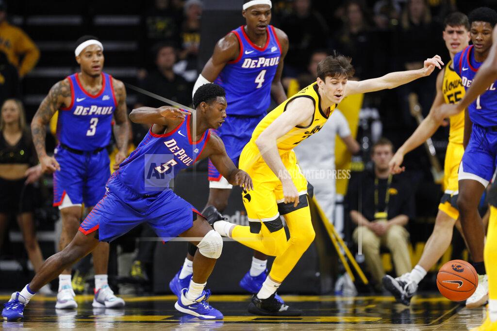Charlie Neibergall DePaul guard Jalen Coleman-Lands (5) fights for a loose ball with Iowa forward Patrick McCaffery during the first half of an NCAA college basketball game, Monday, Nov. 11, 2019, in Iowa City, Iowa. (AP Photo/Charlie Neibergall)