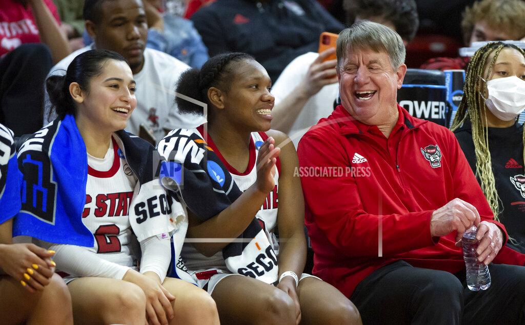 Ben Mckeown North Carolina State head coach Wes Moore, right, laughs with Diamond Johnson, center, and Raina Perez, left, in the final minutes of their victory over Kansas State in a college basketball game in the second round of the NCAA tournament in Raleigh, N.C., Monday, March 21, 2022. (AP Photo/Ben McKeown)