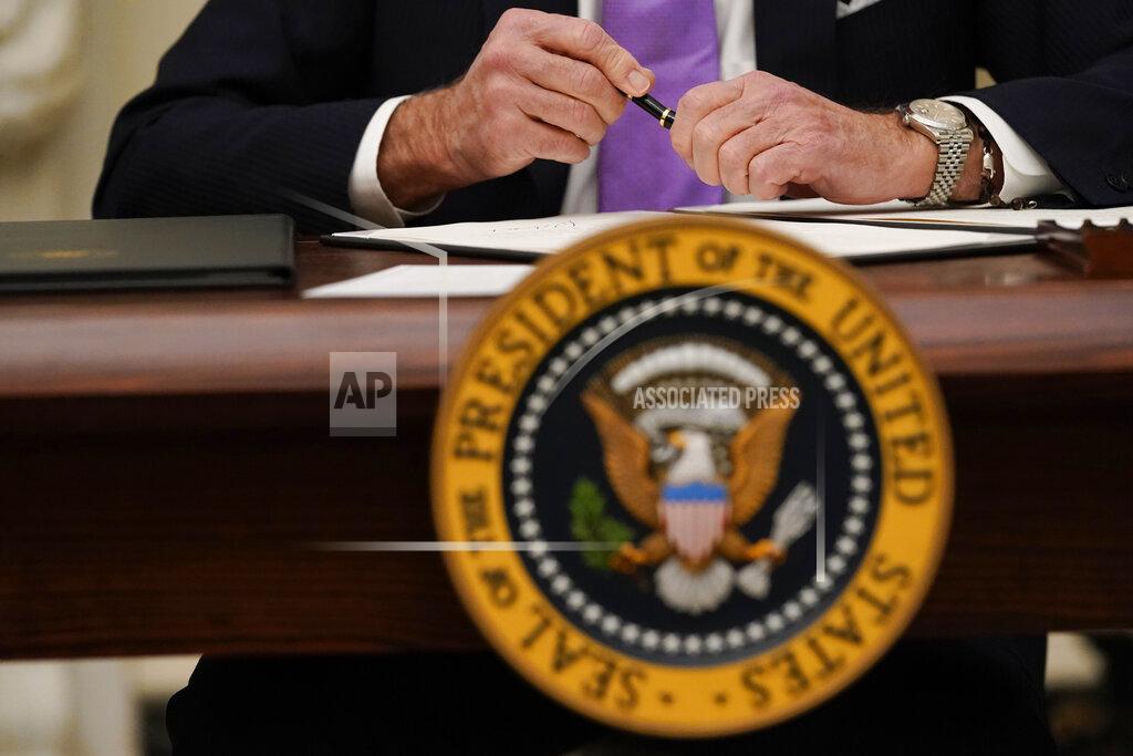 Alex Brandon FILE - Int his Jan. 21, 2021, file photo President Joe Biden puts the cap on a pen after signing an executive order in the State Dinning Room of the White House. (AP Photo/Alex Brandon, File)