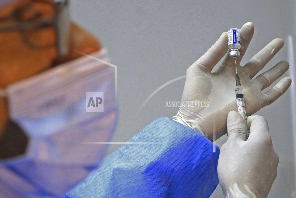Fateh Guidoum A medical staff prepares a syringe with the Sputnik-V COVID-19 at a vaccination center in Blida, south of Algiers, Algeria, Saturday, Jan. 30, 2021. The vaccines were delivered to the Boufarik military airport west of Algiers, Minister Amar Belhimeur said in a statement. He did not indicate how many arrived, though the government had said it had ordered a first batch of 500,000 Sputnik doses. (AP Photo/Fateh Guidoum)