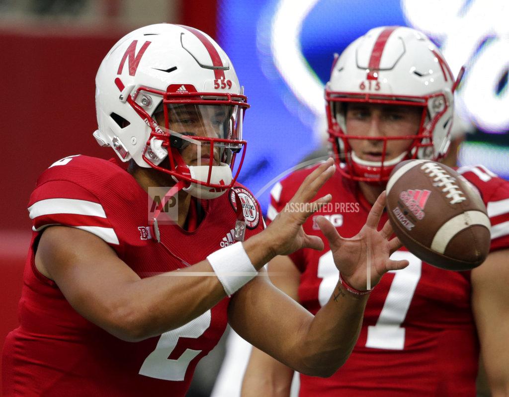 Nati Harnik FILE- In this Sept. 1, 2018, file photo, Nebraska quarterback Andrew Bunch (17) watches as quarterback Adrian Martinez (2) catches the ball before an NCAA college football game against Akron in Lincoln, Neb. The circumstances for Nebraska are far from ideal as it nears its first road game under new coach Scott Frost next week at Michigan. The Cornhuskers went late into this week not knowing the health status of true freshman quarterback Adrian Martinez, making their Saturday game against Troy a little trickier. If Martinez cannot play, sophomore walk-on Andrew Bunch will make his first start. (AP Photo/Nati Harnik)