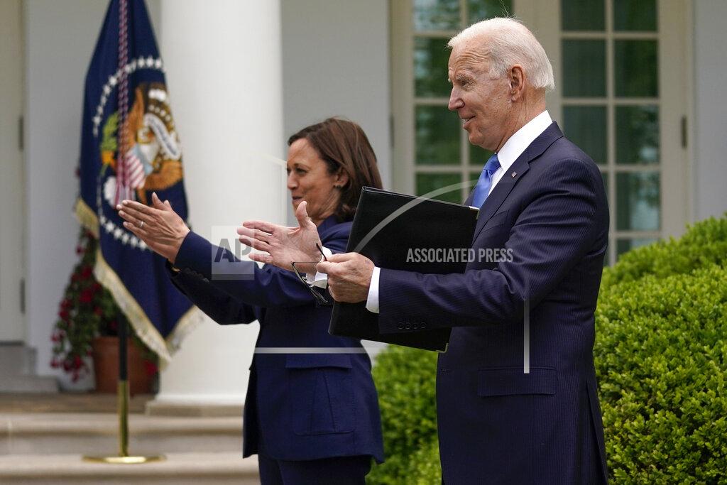 Evan Vucci President Joe Biden claps with Vice President Kamala Harris after speaking on updated guidance on face mask mandates and COVID-19 response, in the Rose Garden of the White House, Thursday, May 13, 2021, in Washington. (AP Photo/Evan Vucci)