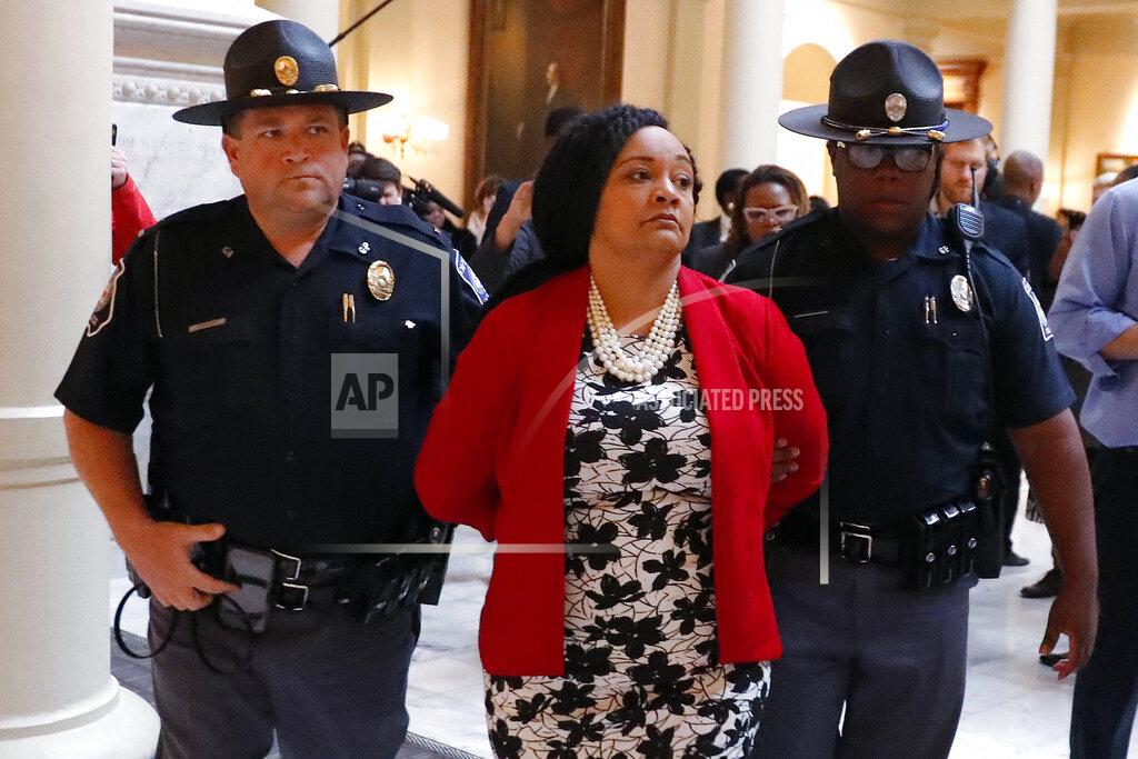John Bazemore FILE - In this Tuesday, Nov. 13, 2018 file photo, Sen. Nikema Williams, D-Atlanta, is detained by capitol police during a protest over election ballot counts in the rotunda of the state capitol building, in Atlanta. "The 2020 election cycle is going to be key to changing the course of history in this country," says Williams, chair of the Democratic party of Georgia, who was selected to replace the late Rep. John Lewis, the civil rights icon who died in July, on the November ballot. "We're a battleground in Georgia now, and Black women are leading the way." (AP Photo/John Bazemore, File)