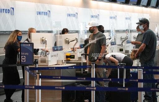 FILE - Travelers well up as agents confer at the United Airlines ticketing counter in Denver International Airport Friday, July 2, 2021, in Denver. United Airlines reported a $473 million profit for the third quarter thanks to more than $1 billion in federal pandemic aid that helped pay airline employees this summer.
The airline said Tuesday, Oct. 19, that bookings started to stabilize last month as the spike in COVID-19 cases eased. (AP Photo/David Zalubowski, File)