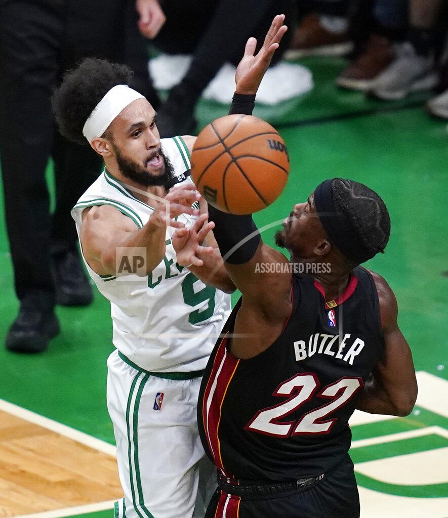 Charles Krupa Boston Celtics guard Derrick White (9) passes the ball while pressured by Miami Heat forward Jimmy Butler (22) during the first half of Game 4 of the NBA basketball playoffs Eastern Conference finals, Monday, May 23, 2022, in Boston. (AP Photo/Charles Krupa)