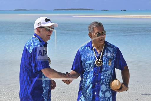 Australia's Prime Minister Anthony Albanese, left, and Tuvalu's Prime Minister Kausea shake hands on One Foot Island after attending the Leaders' Retreat during the Pacific Islands Forum in Aitutaki, Cook Islands, Thursday, Nov. 9, 2023. Australia on Friday offered the island nation of Tuvalu a lifeline to help residents escape the rising seas and increased storms that climate change is bringing. (Mick Tsikas/AAP Image via AP)