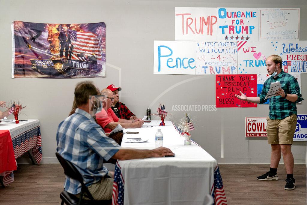 David Goldman Ryan Retza, right, Trump Victory regional field director, leads volunteers in a training event at a campaign office in Appleton, Wis., Aug. 20, 2020. Republicans here say that President Donald Trump propelled the country to new heights with tax and regulatory cuts, only to be brought low by the force majeure of a virus, and that most voters will hold him blameless. (AP Photo/David Goldman)