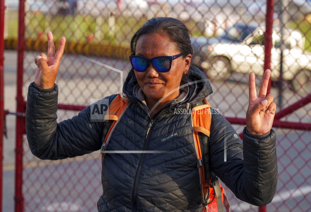 Niranjan Shrestha Nepalese climber Lhakpa Sherpa gestures as she arrives at the airport in Kathmandu, Nepal, Tuesday, May 17, 2022. The Nepali Sherpa broke her own record reaching the 8,849-meter (29,032-foot) summit for a 10th time — the most times any woman has climbed Mount Everest. Sherpa, 48, said she is next planning to scale the world's second-highest peak, K2 in Pakistan. (AP Photo/Niranjan Shrestha)