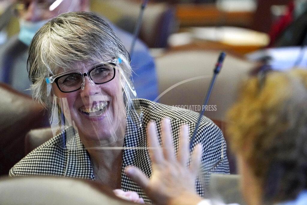 Robert F. Bukaty Rep. Heidi Sampson, R-Alfred, wears a face shield during the first legislative session in the State House since the proceedings were moved to the more spacious Augusta Civic Center, Wednesday, June 2, 2021, in Augusta, Maine. (AP Photo/Robert F. Bukaty)