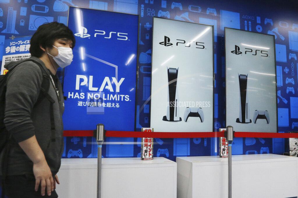 Koji Sasahara A man stands near promotional pictures of Play Station 5 at an electronics retail chain store in Tokyo, Wednesday, April 28, 2021. Sony’s January-March profit zoomed eight-fold to 107 billion yen ($982 million) as people stuck at home during the coronavirus pandemic turned to the Japanese electronics and entertainment company’s video games and other visual content. (AP Photo/Koji Sasahara)