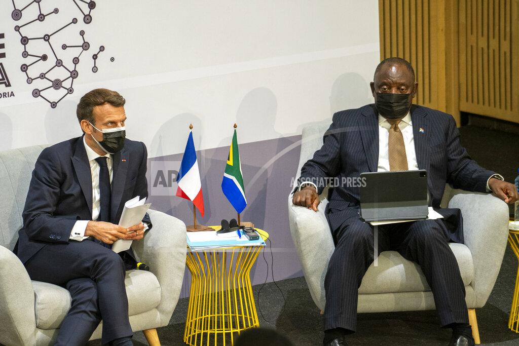 Jerome Delay French President Emmanuel Macron, left, and South African President Cyril Ramaphosa participate Friday May 28, 2021 at the University of Pretoria Future Africa in the launching of a program to support African vaccine production, a project backed by the European Union, the United States and the World Bank. (AP Photo/Jerome Delay)