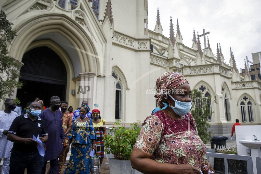 Sunday Alamba Churchgoers wear face masks to curb the spread of the coronavirus as they leave after a Sunday mass at the Holy Cross Cathedral in Lagos, Nigeria Sunday, Aug. 30, 2020. The COVID-19 pandemic is testing the patience of some religious leaders across Africa who worry they will lose followers, and funding, as restrictions on gatherings continue. (AP Photo/Sunday Alamba)