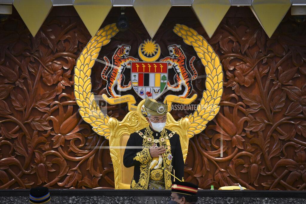 Nazri Rapai In this photo released by Malaysia's Department of Information, Malaysia's King Sultan Abdullah Sultan Ahmad Shah greets during the opening ceremony of the third term of the 14th parliamentary session at parliament house in Kuala Lumpur Monday, May 18, 2020. Malaysia's parliament held an unusual half-day sitting Monday, that was kept short due to the COVID-19 pandemic and saw Prime Minister Muhyiddin Yassin dodge a vote of no-confidence against him over two months since he came into power. (Nazri Rapai/ Malaysia's Department of Information via AP)
